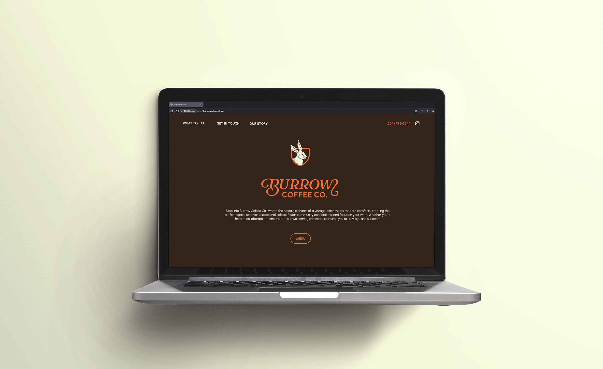 cream background computer in the middle featuring burrow website hero.